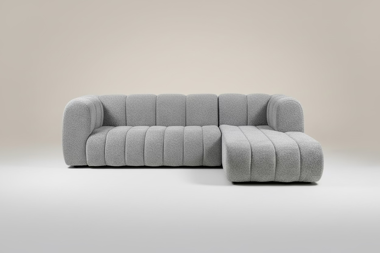 Gray textured sectional sofa in a showroom setting with tables and other furniture. — luxury custom furniture