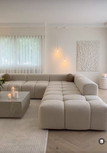 Cumulus modular sectional showing deep channel-tufted seats and rounded arms