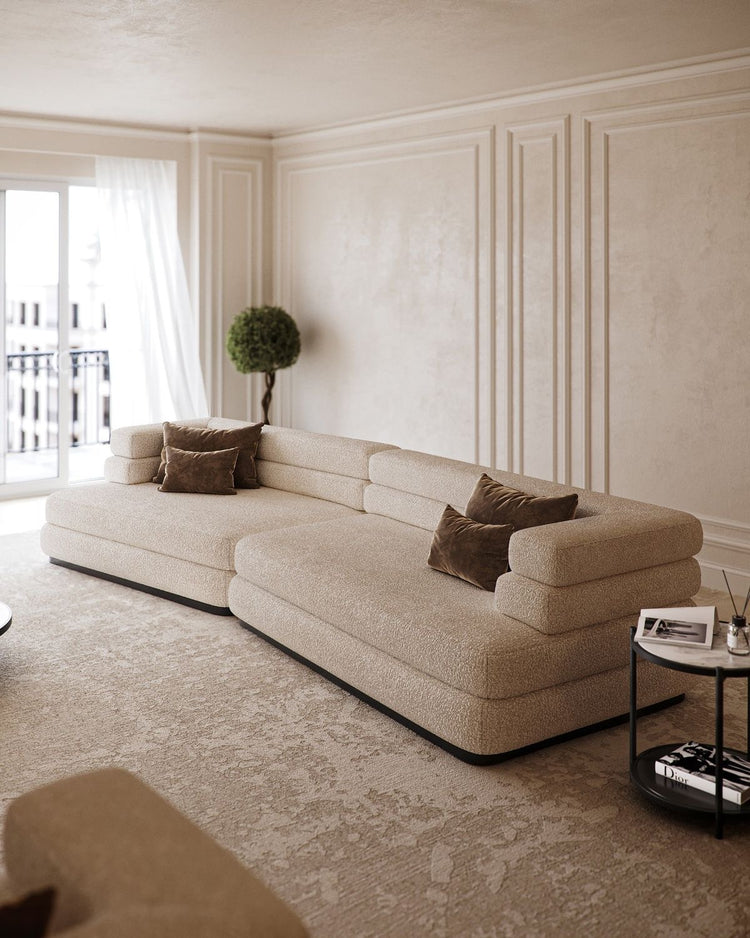 Cream bouclé Meridian daybed sofa with deep seats and low stacked backrests on a black recessed base