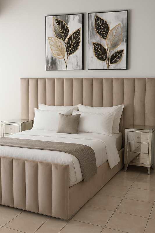 Beige upholstered bed with white bedding and decorative pillows in a bedroom setting.